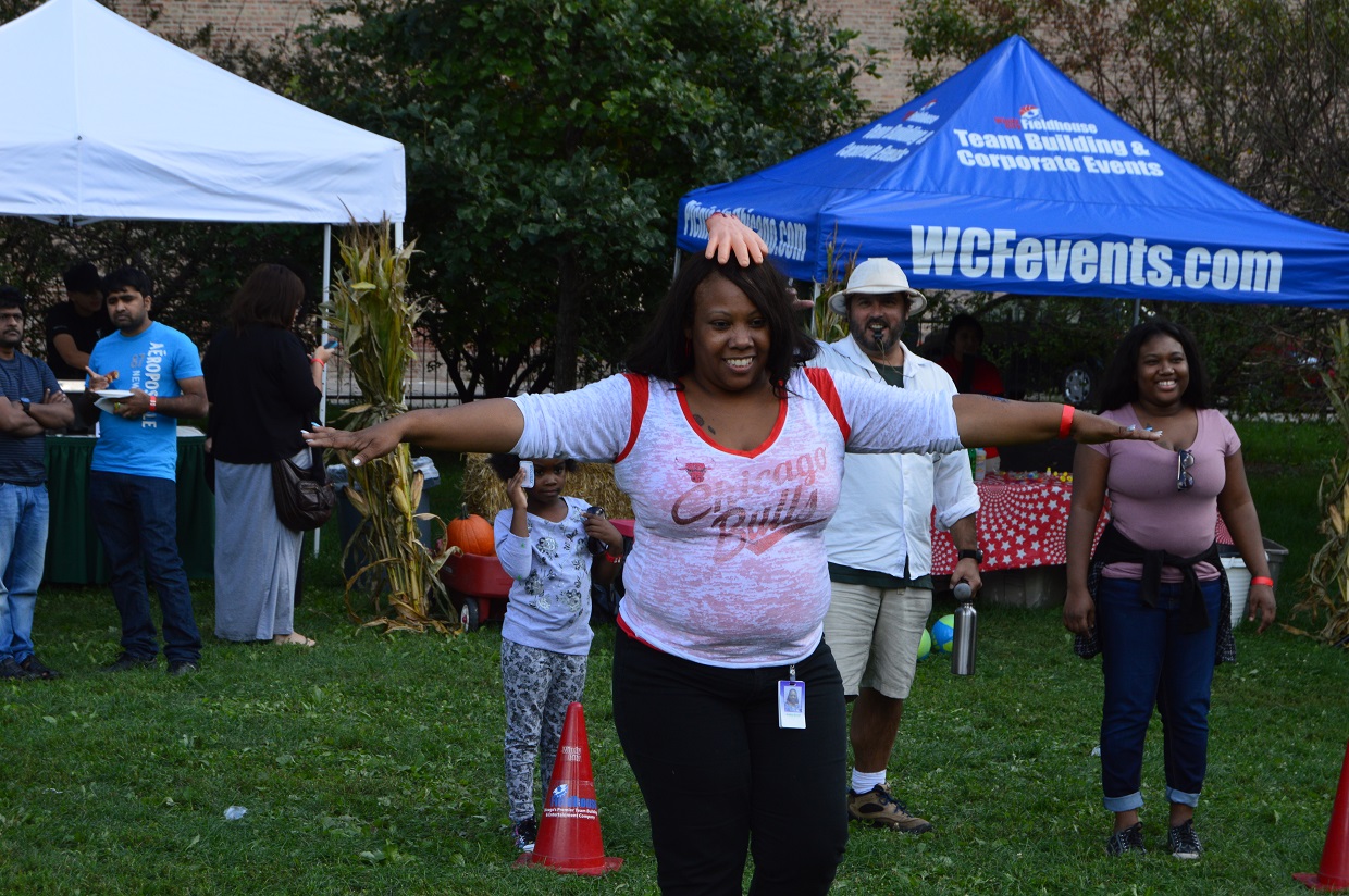 Guests enjoying fall themed relay races at a family fall fest event
