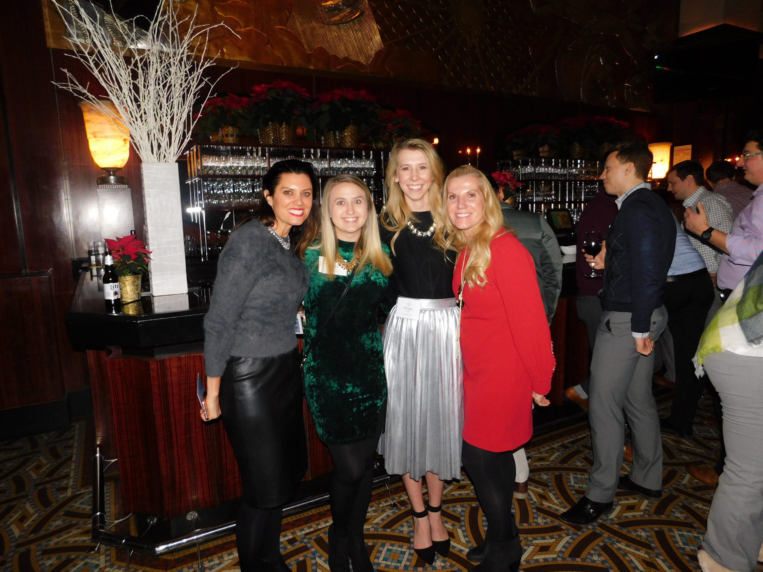 Company Holiday Party Guests posing for a photo with festive outfits