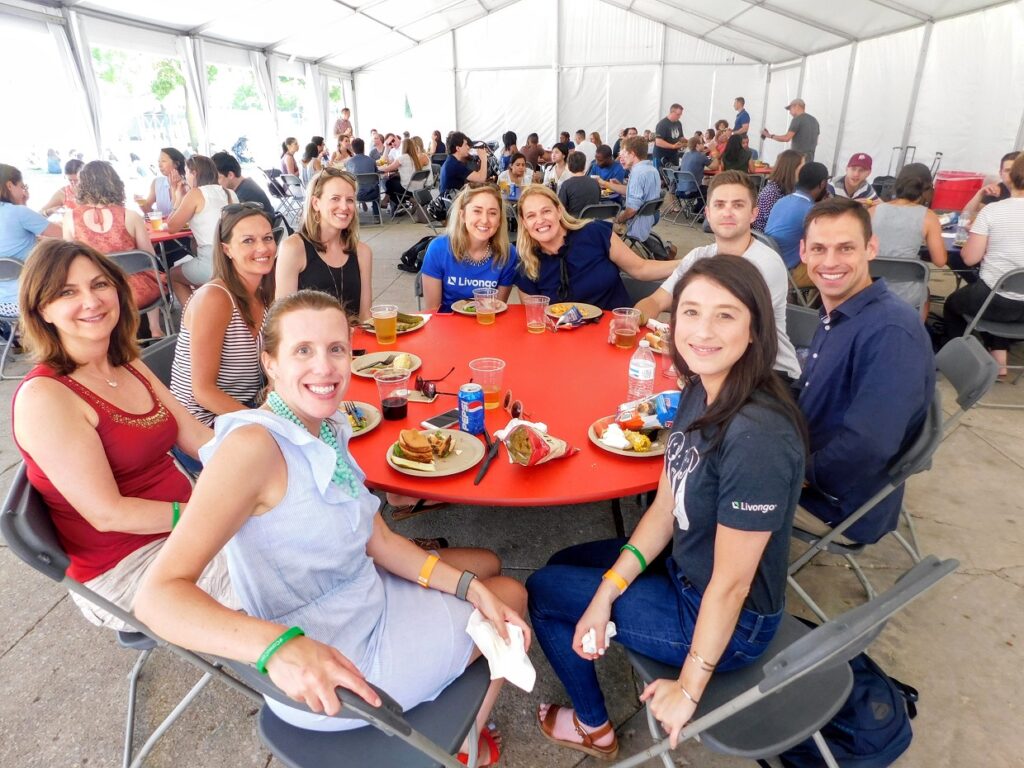 people at summer outings sitting around picnic table